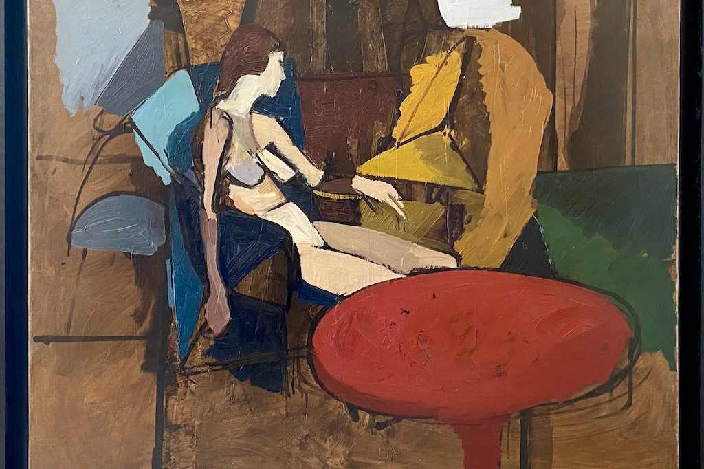nu alangui de Michel Mousseau peint à l'huile sur toile avec une nature morte dont une table rouge d'un grand colorisme.